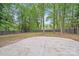 A spacious backyard features lush trees and a concrete patio, perfect for outdoor relaxation and entertainment at 3619 Bankston Pl, Charlotte, NC 28215