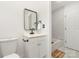 Well-lit bathroom featuring a classic white vanity, toilet, and a tiled shower-tub combination at 3619 Bankston Pl, Charlotte, NC 28215