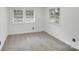 Cozy bedroom featuring neutral paint, plush carpet, and two windows at 3619 Bankston Pl, Charlotte, NC 28215