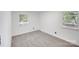 Bright bedroom with neutral paint, plush carpet, two windows and base trim at 3619 Bankston Pl, Charlotte, NC 28215