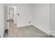 A bright bedroom with neutral walls and carpet boasts an adjoining bathroom and spacious closet at 3619 Bankston Pl, Charlotte, NC 28215