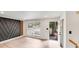 Inviting entryway with wood accent wall, bright white walls, hardwood floors, and view to the outside at 3619 Bankston Pl, Charlotte, NC 28215