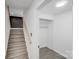 This bright hallway and stairway feature wooden stairs and access to a convenient closet at 3619 Bankston Pl, Charlotte, NC 28215