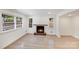 A comfortable living room features a brick fireplace with wooden mantle and multiple windows with charming views at 3619 Bankston Pl, Charlotte, NC 28215