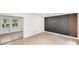A versatile room featuring an accent wall with modern wood design details and light wood floors at 3619 Bankston Pl, Charlotte, NC 28215