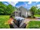 Backyard view featuring a patio area with hot tub, grill, and comfortable outdoor seating arrangement at 3700 Carolina Cherry Ct, Gastonia, NC 28056