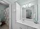 Clean bathroom featuring a neutral wall color, sink, mirror, cabinet, and a shower with a decorative shower curtain at 3700 Carolina Cherry Ct, Gastonia, NC 28056
