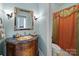 Charming bathroom with antique vanity, marble countertop, and vintage-inspired fixtures at 3700 Carolina Cherry Ct, Gastonia, NC 28056