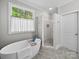 Spa-like bathroom with a soaking tub, walk-in shower, and a tranquil, bright ambiance at 3700 Carolina Cherry Ct, Gastonia, NC 28056