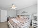 Bedroom featuring neutral walls, a decorative headboard, a ceiling fan, and a comfortable bed at 3700 Carolina Cherry Ct, Gastonia, NC 28056