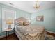 Bright bedroom with wood floors, neutral colored walls, chandelier, and two windows allowing plenty of natural light at 3700 Carolina Cherry Ct, Gastonia, NC 28056