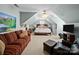 Angled bedroom with neutral carpet, a bed, furniture, a red couch, a ceiling fan, and soft colored walls at 3700 Carolina Cherry Ct, Gastonia, NC 28056