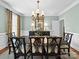 Dining room features an elegant chandelier, a buffet table and a long dark wood table at 3700 Carolina Cherry Ct, Gastonia, NC 28056