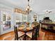 Elegant dining area featuring a round table, ornate chandelier, and view into the living space at 3700 Carolina Cherry Ct, Gastonia, NC 28056
