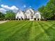 Charming white home with a lush green lawn and beautifully landscaped yard at 3700 Carolina Cherry Ct, Gastonia, NC 28056