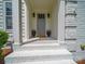 Inviting front porch with classic columns and decorative flower pots adding to the curb appeal at 3700 Carolina Cherry Ct, Gastonia, NC 28056