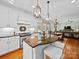 Kitchen with white cabinetry, a granite island, and view of the dining area and living room at 3700 Carolina Cherry Ct, Gastonia, NC 28056
