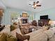 Cozy living room featuring a fireplace, ceiling fan, and comfortable seating arrangement at 3700 Carolina Cherry Ct, Gastonia, NC 28056