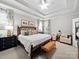 Bright, airy main bedroom with tray ceilings, a king bed, and a cozy sitting area at 3700 Carolina Cherry Ct, Gastonia, NC 28056