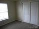 Bright bedroom features carpet and window providing ample natural light at 391 Morning Dew Dr, Concord, NC 28025