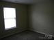 Bright bedroom features carpet and window providing ample natural light at 391 Morning Dew Dr, Concord, NC 28025