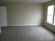 Bedroom with new carpet, neutral walls, an in-room window, and white door that enhances natural light at 391 Morning Dew Dr, Concord, NC 28025