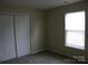 Neutral carpeted bedroom features natural light and a closet at 391 Morning Dew Dr, Concord, NC 28025