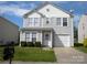 Charming two-story home features a well-maintained lawn, attached garage, and classic architectural details at 391 Morning Dew Dr, Concord, NC 28025