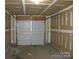 Unfinished garage features a standard white garage door at 391 Morning Dew Dr, Concord, NC 28025