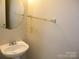 Clean half bathroom features a pedestal sink, mirror, and wall-mounted towel bar at 391 Morning Dew Dr, Concord, NC 28025