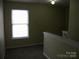 Upstairs hallway featuring neutral walls, new carpet, and natural light from a bright window at 391 Morning Dew Dr, Concord, NC 28025