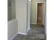 Hallway view with neutral walls and new carpet that leads to an open bathroom with tile flooring at 391 Morning Dew Dr, Concord, NC 28025
