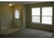 Bright living room featuring neutral walls, plush carpeting, and large windows with natural light at 391 Morning Dew Dr, Concord, NC 28025