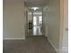 Open living room boasts neutral walls, plush carpeting, tile, and view of kitchen and staircase at 391 Morning Dew Dr, Concord, NC 28025