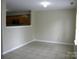 Open living room with tile flooring and neutral paint offering potential for customization at 391 Morning Dew Dr, Concord, NC 28025