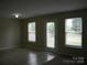 Bright living room with tile floor, neutral walls, and multiple windows offering natural light at 391 Morning Dew Dr, Concord, NC 28025
