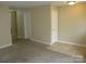 Spacious living room with neutral walls, plush carpeting, and tile entryway near interior doors at 391 Morning Dew Dr, Concord, NC 28025