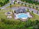 Community pool and recreation center with playground, lounge chairs, and ample parking surrounded by lush greenery at 4008 Pinot Way, Fort Mill, SC 29707