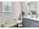 Half bathroom features a grey vanity, large mirror, and contemporary finishes at 4008 Pinot Way, Fort Mill, SC 29707