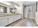 This bathroom features a tile floor, double vanity, walk-in shower and white cabinets at 4008 Pinot Way, Fort Mill, SC 29707