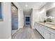 This bathroom has a tile floor, double vanity, walk-in shower and white cabinets at 4008 Pinot Way, Fort Mill, SC 29707