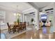 Formal dining room featuring a chandelier, hardwood floors, and a connection to the living area at 4008 Pinot Way, Fort Mill, SC 29707