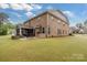 View of the home highlighting a brick exterior, patio, screened porch, and a well-maintained lawn at 4008 Pinot Way, Fort Mill, SC 29707