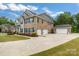 Spacious home features a three-car garage and a detached single-car garage with large concrete driveway at 4008 Pinot Way, Fort Mill, SC 29707