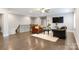 This living room features hardwood floors, seating and a ceiling fan at 4008 Pinot Way, Fort Mill, SC 29707