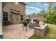Brick patio with outdoor seating, a stone fire pit, and a grill; great for entertaining and relaxing outdoors at 4008 Pinot Way, Fort Mill, SC 29707