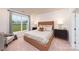 Cozy bedroom with a plush bed, soft carpeting, and a view of the green landscape outside the window at 4206 Steel Way, Sherrills Ford, NC 28673