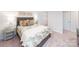 Bright bedroom featuring a bed with a grey frame, pillows, and a large window with natural light at 4208 Steel Way, Sherrills Ford, NC 28673
