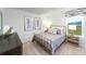 A cozy bedroom with a metal bed frame, decorative art, and a bright window with a field view at 4208 Steel Way, Sherrills Ford, NC 28673