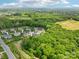 Expansive aerial view of a neighborhood surrounded by lush greenery and trees at 500 Chicory Cir, Matthews, NC 28104